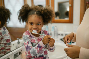 Child Brushing Her Teeth 300x200